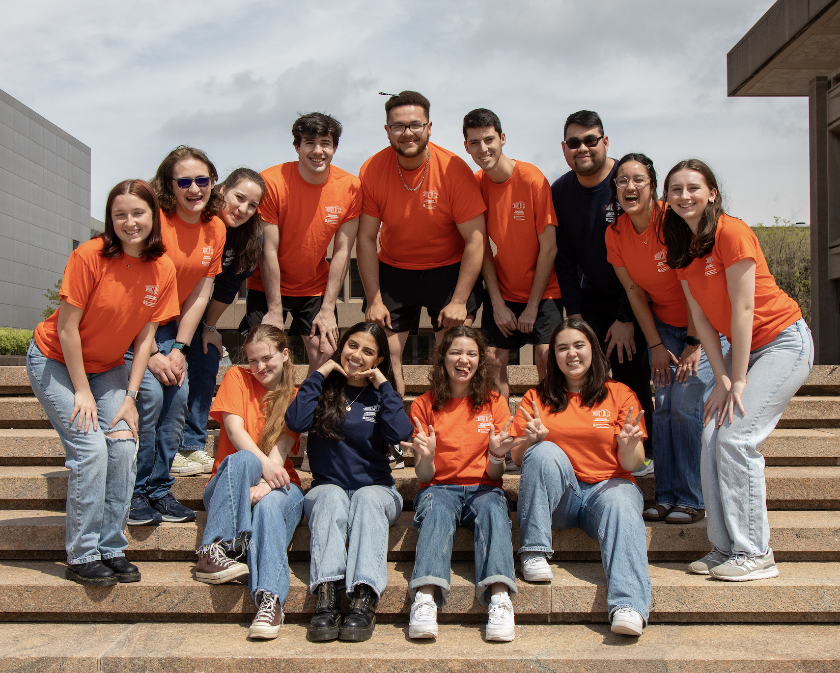 a group of people posing on a set of steps outside